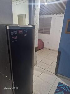 a black trash can sitting in a room at Recanto do Leâo in Guarujá