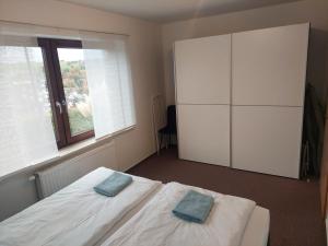a bedroom with a bed and a large window at Ferienwohnung Familie Aestel in Altensteig +9 photos