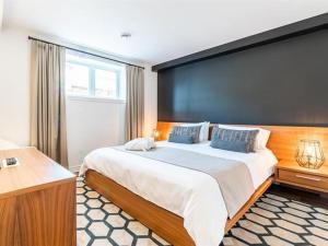 a bedroom with a large bed with a large wall at 2 bedroom condo Ski in Ski out Sommets St-Sauveur in Saint-Sauveur-des-Monts