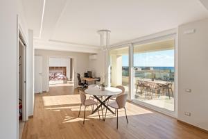 a dining room and living room with a table and chairs at Lantern Penthouse in Salerno +55 photos