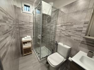 a bathroom with a shower and a toilet and a sink at DM Rooms in Catania