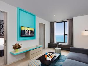 a living room with a couch and a tv at ibis Styles Nha Trang in Nha Trang