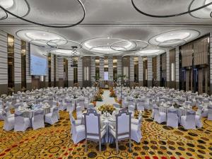 a large banquet hall with white tables and chairs at Pullman Kuala Lumpur City Centre Hotel & Residences in Kuala Lumpur +199 photos