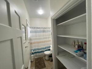 a small bathroom with a toilet and a shower at Wolfville Veranda Suite 1 Downtown Vibrancy in Wolfville