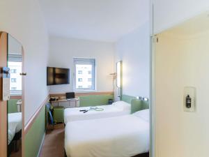 Ένα ή περισσότερα κρεβάτια σε δωμάτιο στο Hotel ibis Budget Porto Gaia