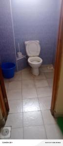 a bathroom with a toilet in a blue wall at Langata bnb in Nairobi