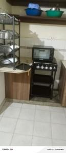 a kitchen with a stove top oven in a kitchen at Langata bnb in Nairobi