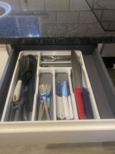 a drawer filled with utensils in a kitchen at Eastcote 1st Floor Retreat 2 Bedroom Suite with Kitchen and Bathroom 2mins to Tube 20mins to Heathrow and Wembley 25mins Drive to Harry Potter World FREE PARKING in Eastcote