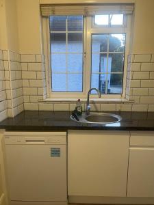 a kitchen with a sink and a window at Eastcote 1st Floor Retreat 2 Bedroom Suite with Kitchen and Bathroom 2mins to Tube 20mins to Heathrow and Wembley 25mins Drive to Harry Potter World FREE PARKING in Eastcote