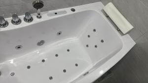 a white bath tub in a bathroom at Lovely Flat with Great Central Location Kaunas in Kaunas