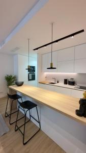 a kitchen with a counter and two stools at Timeless - O`Clock in Lisbon +13 photos