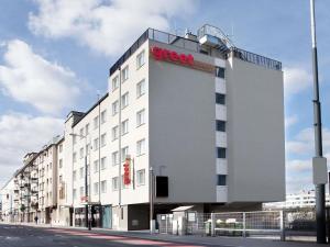 a large white building with a street sign on it at greet Wien City Nord in Vienna