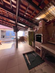 eine Küche mit Steinofen und Tisch in der Unterkunft casa da hilda in Pirenópolis