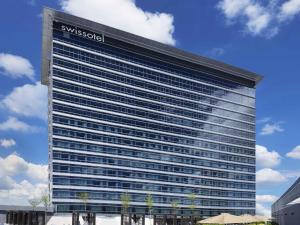 a large building with a sign on the side of it at Swissôtel Clark Philippines in Clark