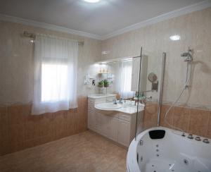 a bathroom with a tub and a sink and a shower at Casa Rural La Libélula Azul in Polán +52 photos