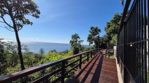 a wooden balcony with a view of the ocean at Vila Encantada – Ponta de Pedras in Ilha Arapiuns