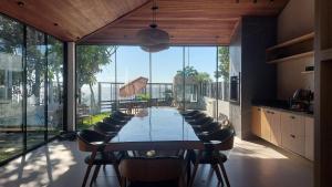 a large dining room with a long table and chairs at Vila Encantada – Ponta de Pedras in Ilha Arapiuns