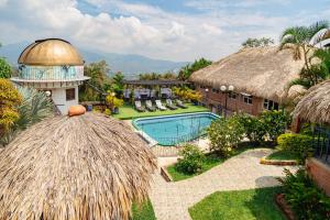 a resort with a swimming pool and a building at Ecovilla Cali in Cali