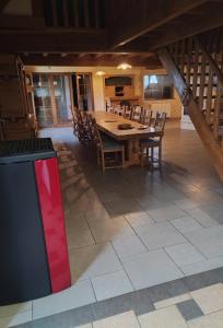 a dining room with a wooden table and chairs at Gîte du Tronquoy in Aix-en-Ergny