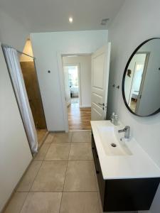 a bathroom with a sink and a mirror at F27-1 3 people, 3 bedrooms, fully furnished in Aalborg