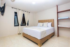 a bedroom with a large bed in a room at Hotel Bossanova in Rionegro +39 photos