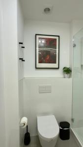 a bathroom with a toilet and a picture on the wall at Timeless - O`Clock in Lisbon