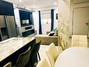 a kitchen and living room with a table and chairs at Modern 4-Bedroom Villa with Private Pool & 2 Baths in Taʼ Ċantar