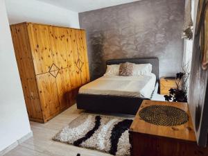 a bedroom with a bed with a wooden wall at Modern 4-Bedroom Villa with Private Pool & 2 Baths in Taʼ Ċantar