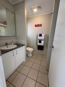 a bathroom with a sink and a toilet at Ash Grove Boutique Motel in Paihia +27 photos
