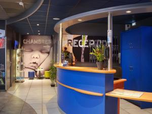 a store with a blue counter in a room at ibis budget Toulouse Centre Gare in Toulouse