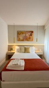 a bedroom with a large bed with a red blanket at Timeless - O`Clock in Lisbon