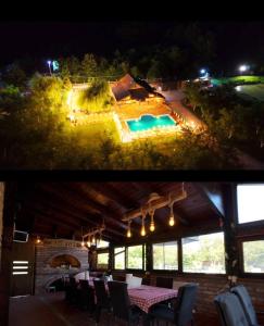 a patio with a table and a swimming pool at night at Ranč Lipe in Orašje