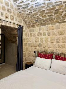 a bedroom with a bed in a stone wall at Evar Konağı in Mardin
