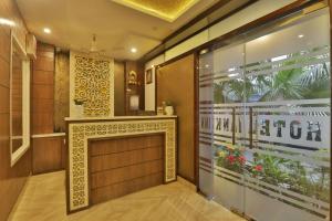 a lobby with a fireplace in a building at Hotel Jhanki Residency Near Kashi Temple in Varanasi