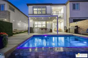 a swimming pool in front of a house at 4BR Private Pool Villa with Arcade Lanai and Water View in Indio