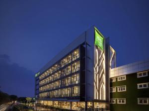 a large building with a sign on the side of it at Ibis Styles Jakarta Sunter in Jakarta