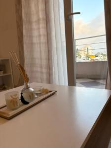 a white counter with two candles and a window at Apartman Solis in Igalo