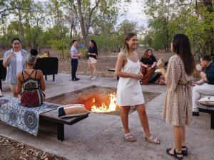 a group of people standing around a fire pit at Mercure Kakadu Crocodile in Jabiru +100 photos