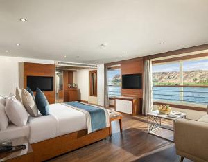a bedroom with a large bed and a living room at Nile Cruise 3 & 4 & 7 Nights in Luxor +25 photos