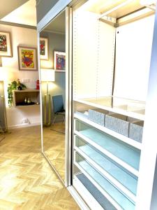 a sliding glass door in a room with a desk at Le QG des Super Héros Marvel in Nevers