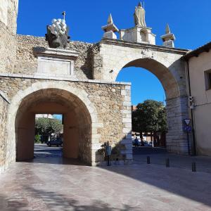 an entrance to a stone building with two archways at La Casa de los Osorios in León