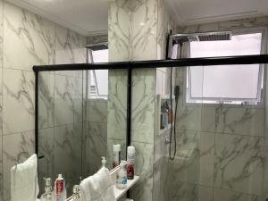 a bathroom with a shower with a glass door at Apartamento Proximo ao Salvador Shopping in Salvador +19 photos