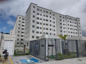 a white building with a motorcycle parked in front of it at Apartamento Proximo ao Salvador Shopping in Salvador