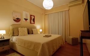 a bedroom with a large bed and a window at AnyfApartment Kalamata in Kalamata