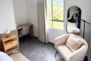 a room with a chair and a desk and a window at Apartamento completo en Sabaneta in Sabaneta +26 photos