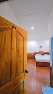 a bedroom with a bed and a wooden cabinet at Home 24 Pattaya in Pattaya