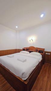 a bedroom with a large bed with white sheets at Home 24 Pattaya in Pattaya +46 photos