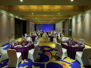 a banquet hall with tables and chairs in a room at Grand Mercure Mysore - An Accor Brand in Mysore +114 photos