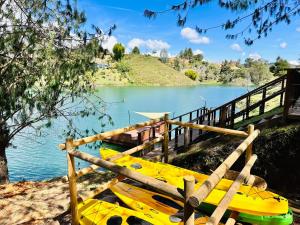 a group of yellow boats parked next to a lake at Exclusive Villa - Lake View - Forest in La Pradera