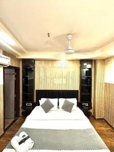 a bedroom with a large bed with two phones on it at Hotel Red Stone - 3 Mins from Railway Station and 5 Mins from Metro in New Delhi